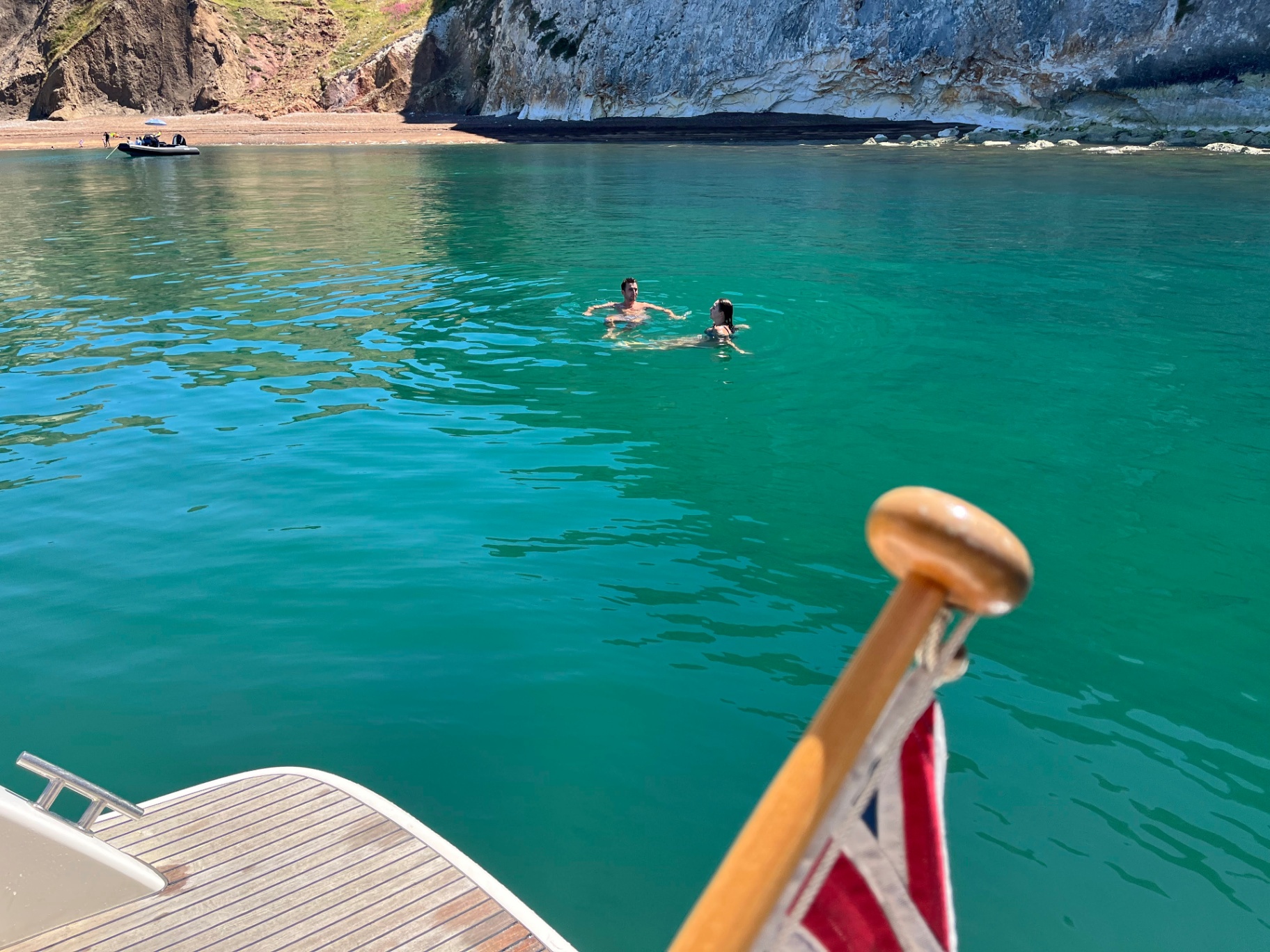 Swimming in crystal clear turquoise water beneath the dramatic cliffs of the Isle of Wight, one of the Solent's best swimming spots